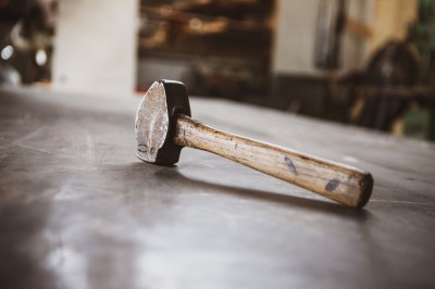 A hammer sitting on a metal surface